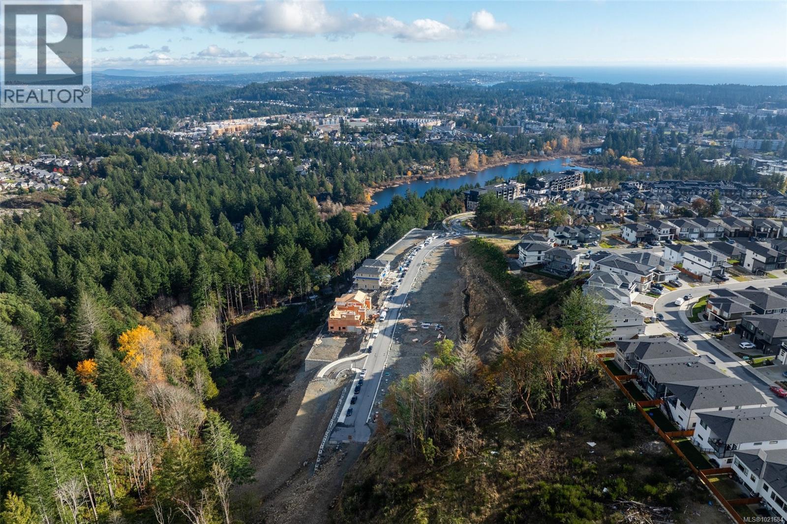 Aerial overview of property's location featuring a large body of water and nearby suburban area - 1204 Cedarbrook Way, Langford, BC