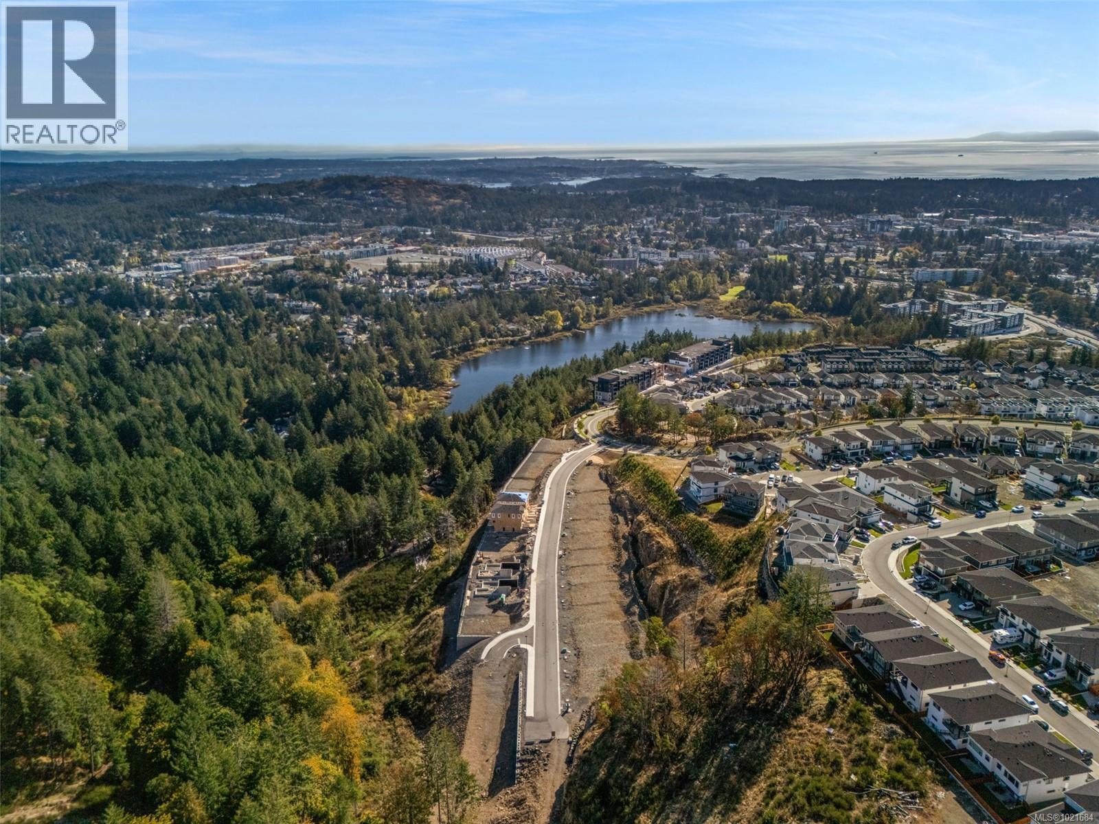Aerial view of property's location with a nearby body of water and nearby suburban area - 1204 Cedarbrook Way, Langford, BC