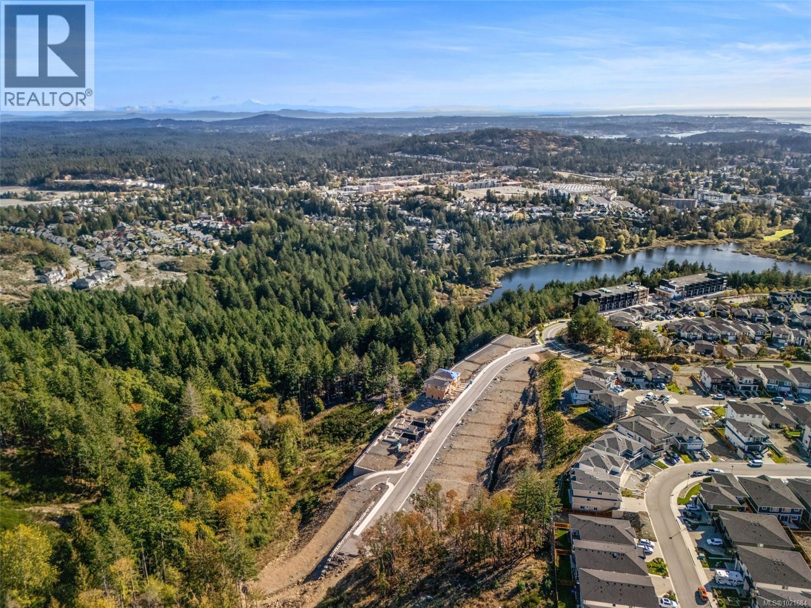 Aerial view of property and surrounding area featuring nearby suburban area and a water and mountain view - 1204 Cedarbrook Way, Langford, BC