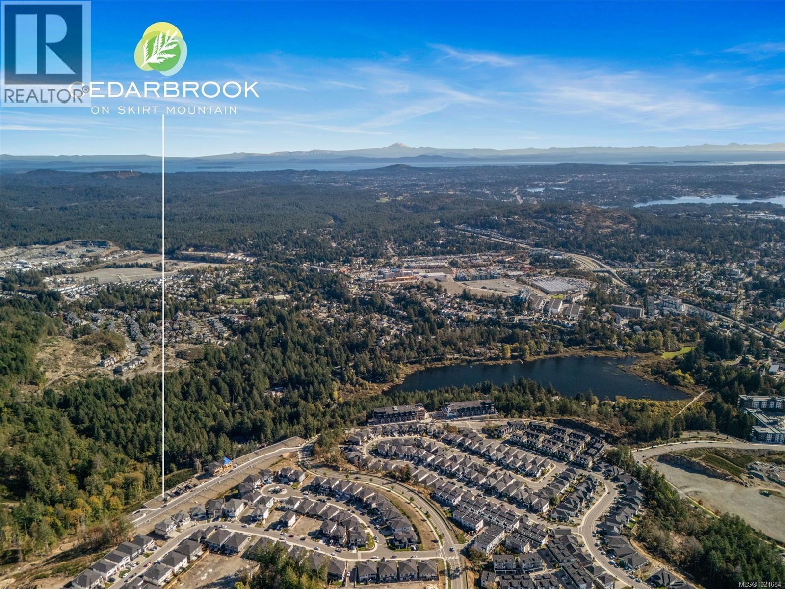Aerial overview of property's location featuring a water and mountain view and nearby suburban area - 1204 Cedarbrook Way, Langford, BC