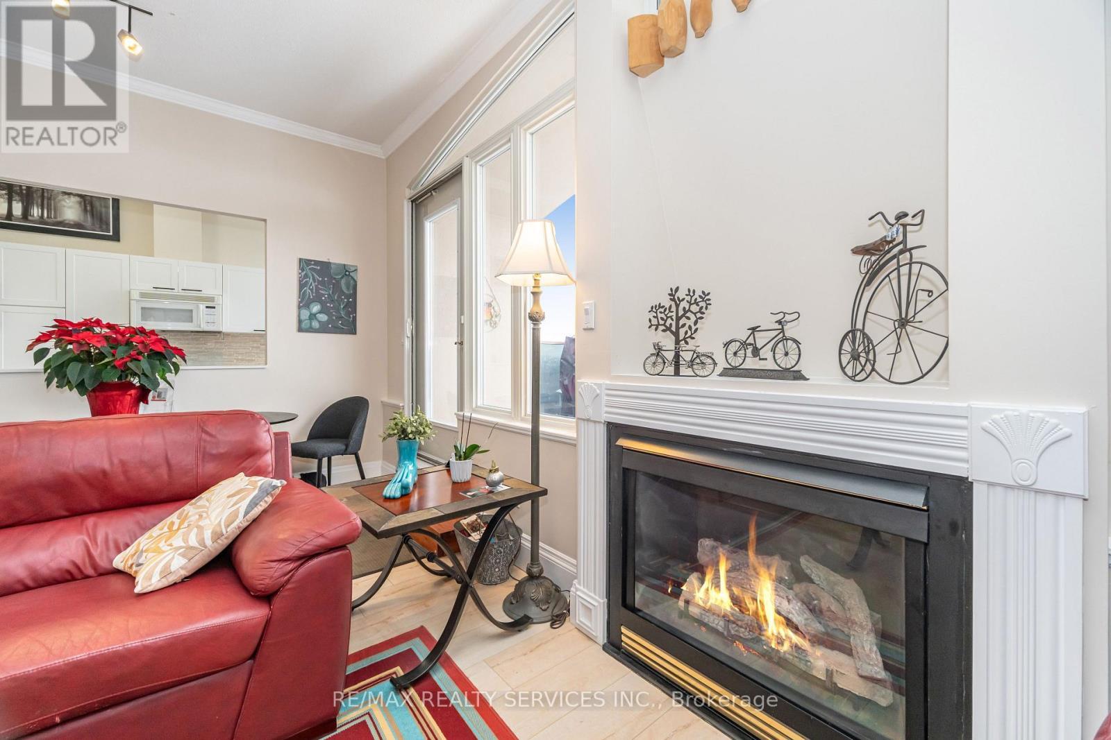 703 - 7 Dayspring Circle, Brampton, ON - Indoor Photo Showing Living Room With Fireplace