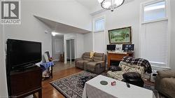 Living room with dark wood finished floors and a towering ceiling -