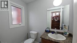 Half bathroom with vanity and toilet -