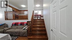 Stairway featuring wood finished floors -