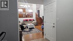 Living area featuring light wood-style floors and a chandelier -
