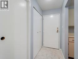 Corridor featuring a textured ceiling and carpet -