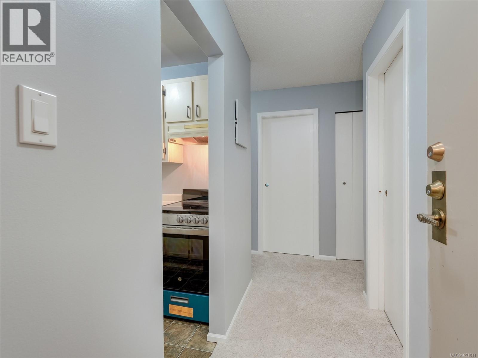 Hall featuring light colored carpet and baseboards - 302 859 Carrie St, Esquimalt, BC - Indoor Photo Showing Other Room