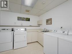 Washroom with washing machine and dryer and cabinet space -