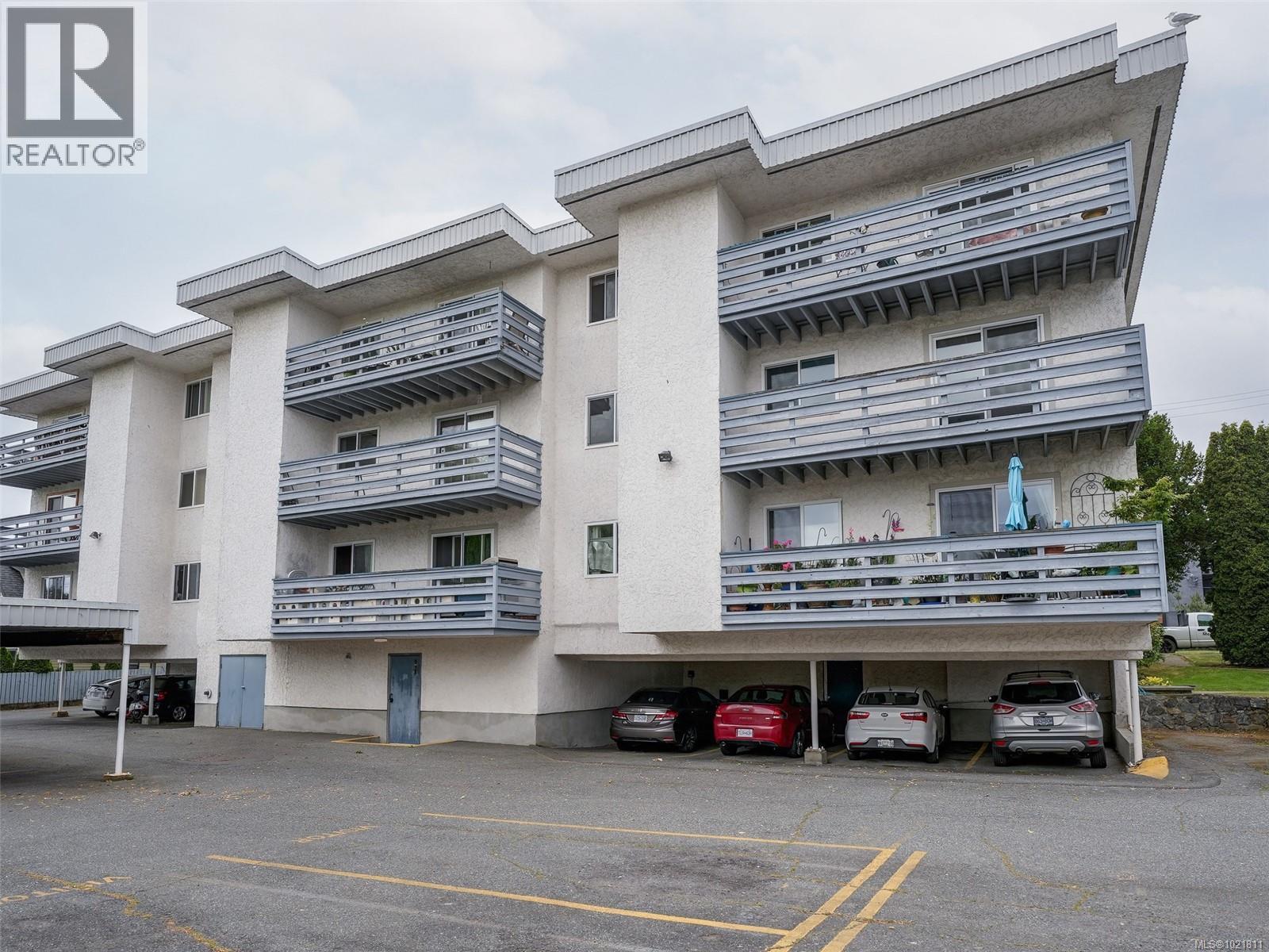 View of apartment building / complex with covered parking - 302 859 Carrie St, Esquimalt, BC - Outdoor With Balcony