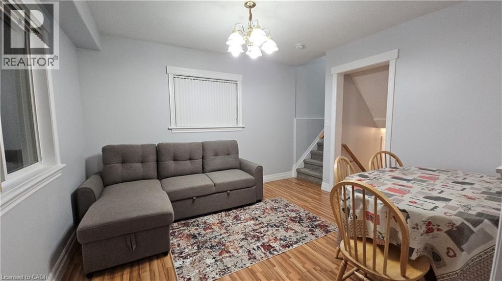 Bedroom featuring a chandelier and light wood-type flooring - 10 Doll Court Unit# Lower, Kitchener, ON - Indoor