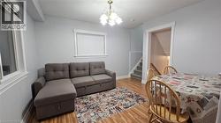 Bedroom featuring a chandelier and light wood-type flooring -