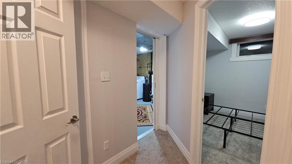 Hall featuring carpet floors and a textured ceiling - 10 Doll Court Unit# Lower, Kitchener, ON - Indoor Photo Showing Other Room