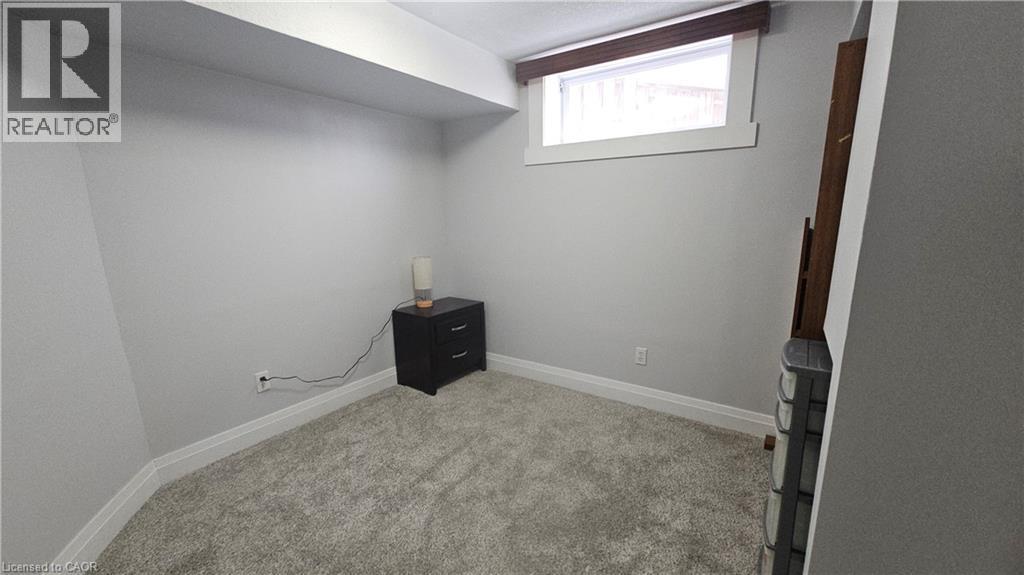 Bedroom featuring light carpet and baseboards - 10 Doll Court Unit# Lower, Kitchener, ON - Indoor Photo Showing Other Room