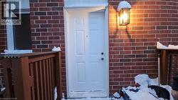 Property entrance featuring brick siding -