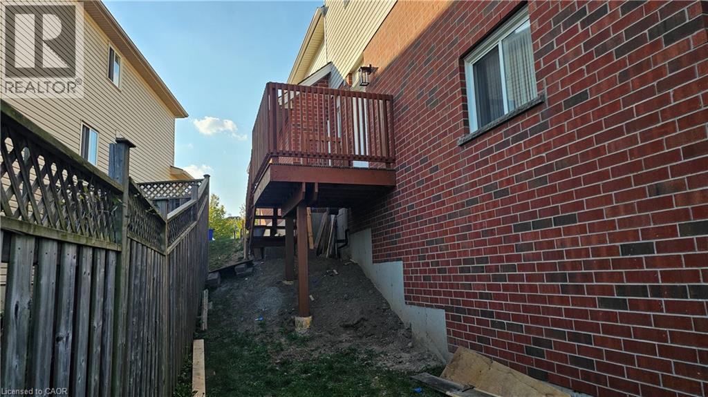 View of property exterior featuring brick siding and stairs - 10 Doll Court Unit# Lower, Kitchener, ON - Outdoor With Exterior