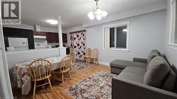Dining area featuring light wood-type flooring and a chandelier -