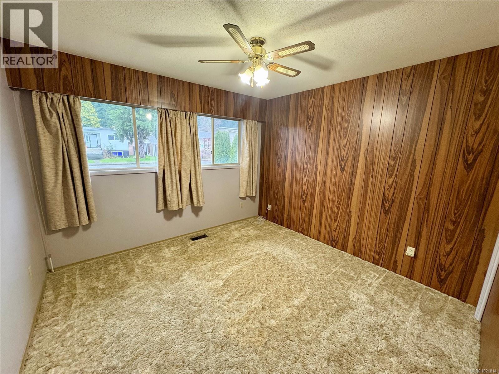Carpeted empty room with a textured ceiling and ceiling fan - 2738 14Th Ave, Port Alberni, BC - Indoor Photo Showing Other Room