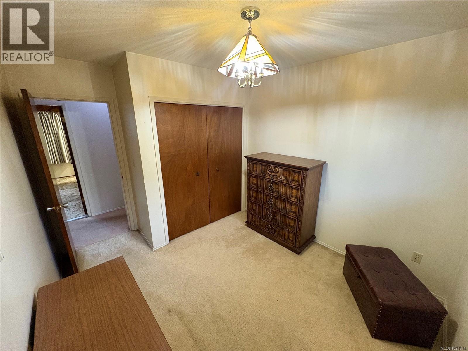 Unfurnished bedroom with a closet, carpet floors, and a chandelier - 2738 14Th Ave, Port Alberni, BC - Indoor Photo Showing Other Room