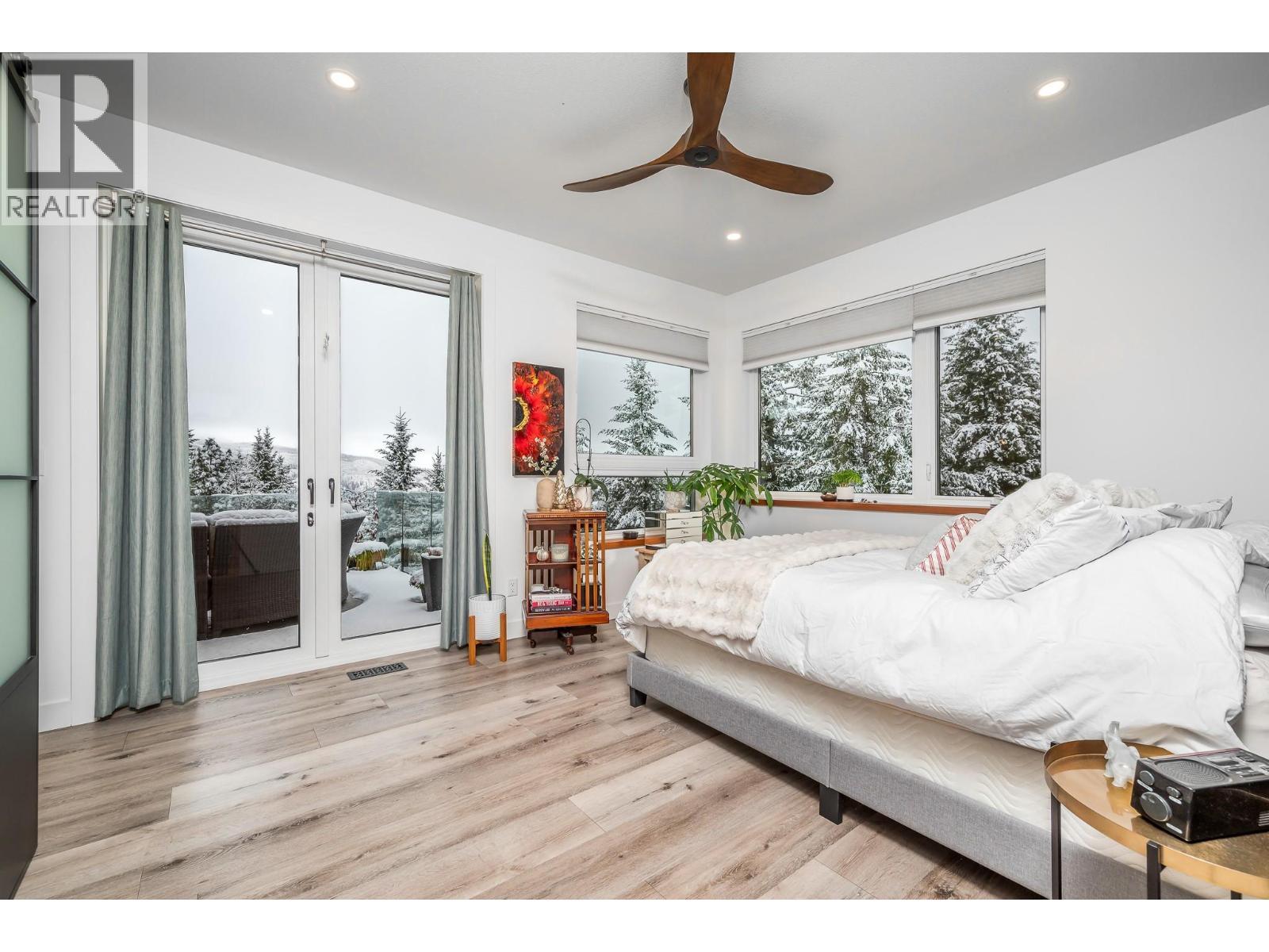 Dbl doors onto deck and views - 9196 Tronson Road Unit# 29, Vernon, BC - Indoor Photo Showing Bedroom