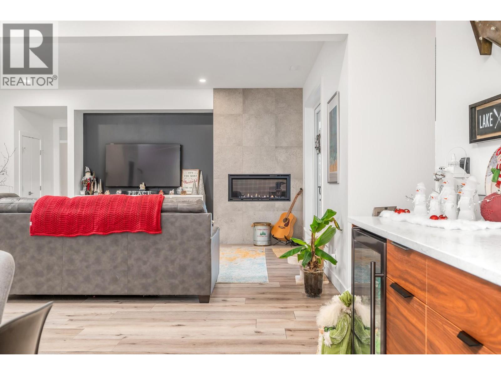 Lower level: Rec room - 9196 Tronson Road Unit# 29, Vernon, BC - Indoor Photo Showing Living Room With Fireplace