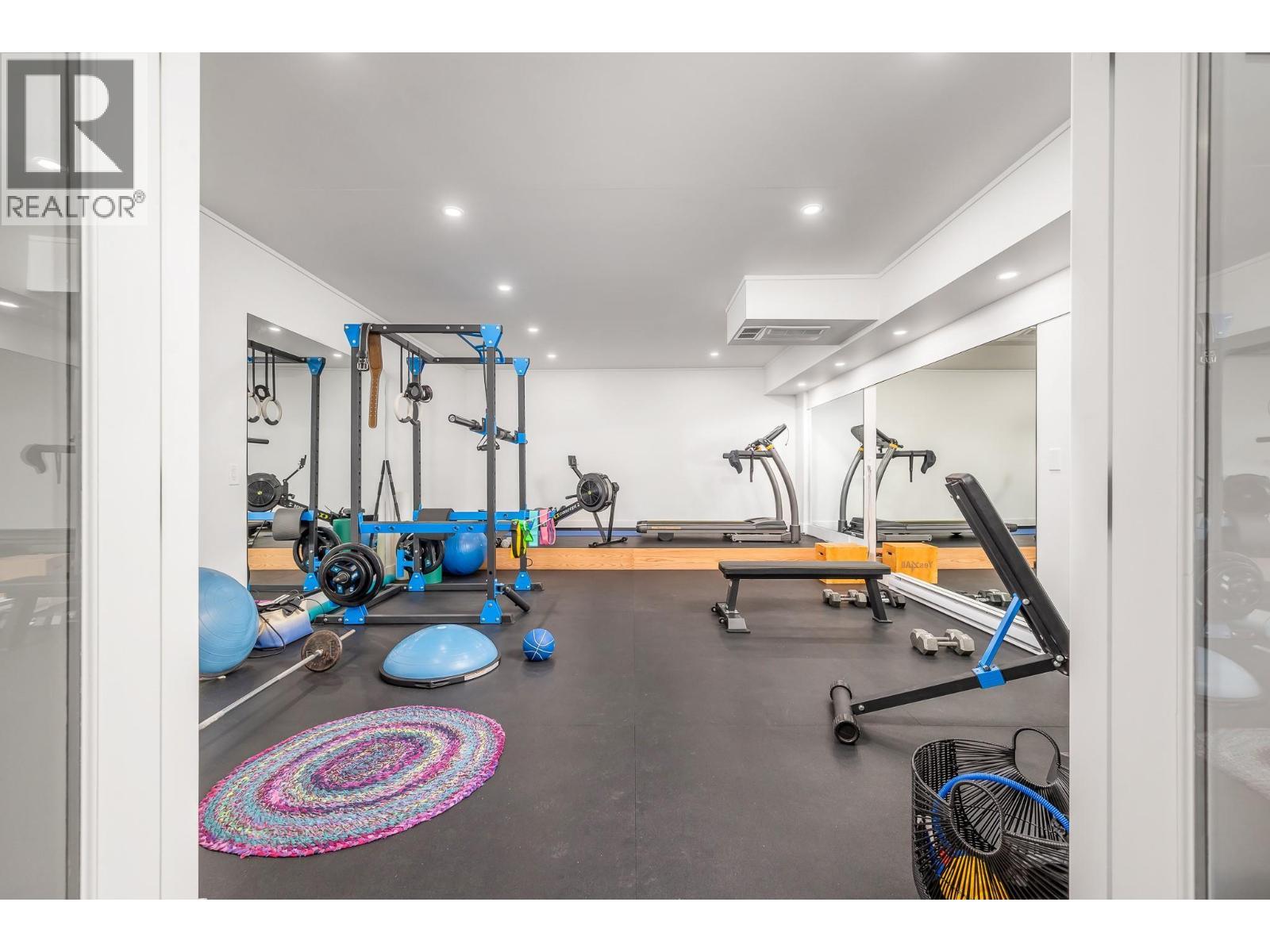 Gym located under the garage - 9196 Tronson Road Unit# 29, Vernon, BC - Indoor Photo Showing Gym Room