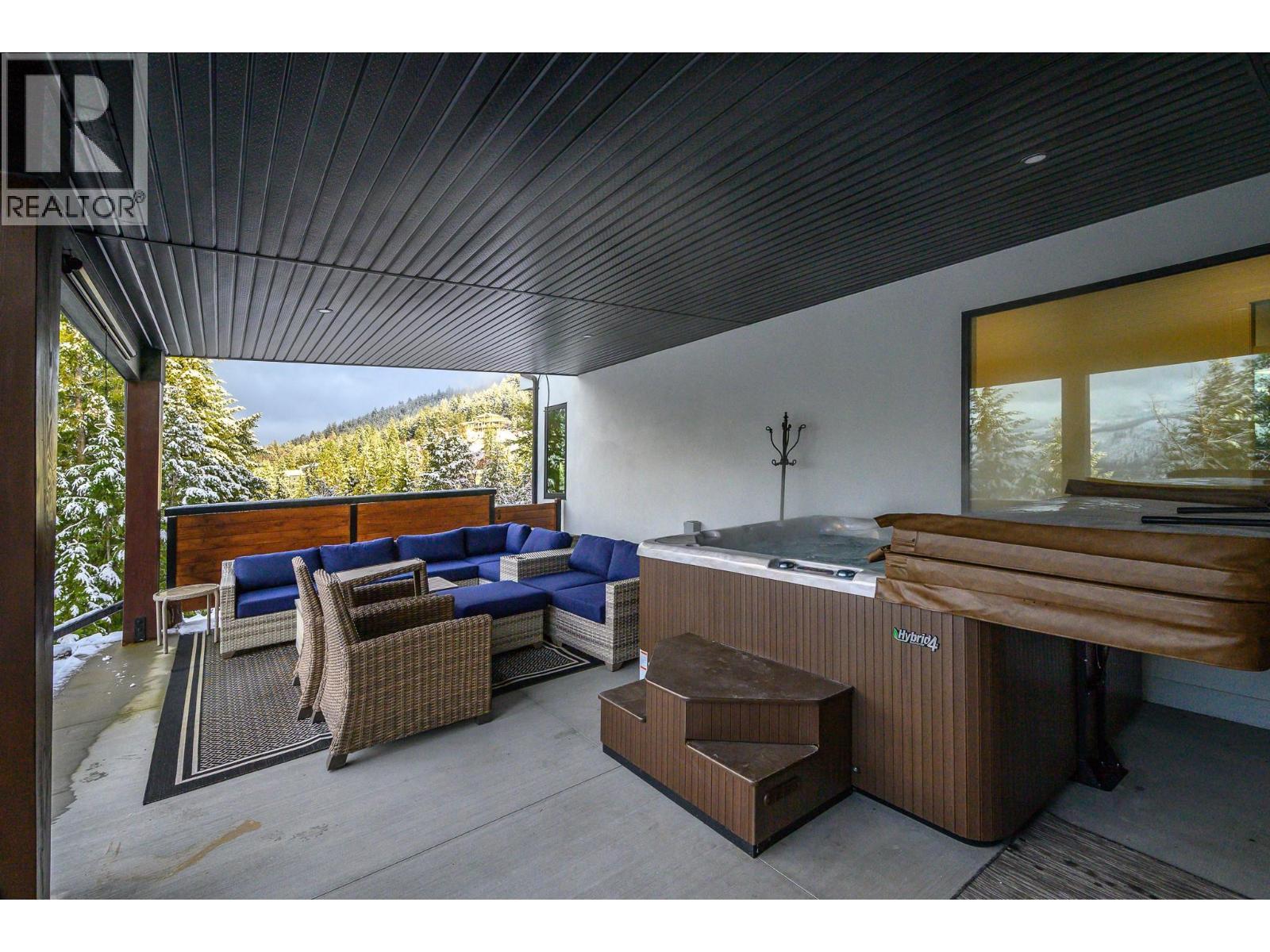 Lower level deck with outdoor theatre screen - 9196 Tronson Road Unit# 29, Vernon, BC - Outdoor With Deck Patio Veranda With Exterior