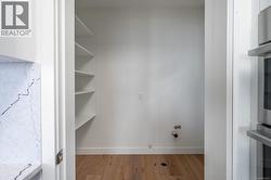 Washroom with wood finished floors and gas dryer hookup -