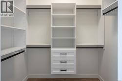 Spacious closet with wood finished floors -