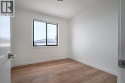 Unfurnished room with light wood-style floors and baseboards -