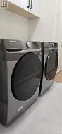 Laundry room with washer and dryer, light wood finished floors, and cabinet space -