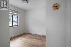 Unfurnished room featuring light wood-style floors and baseboards -