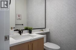 Half bath featuring vanity and toilet -