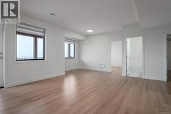 Empty room featuring baseboards and light wood-type flooring -