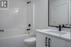 Full bath featuring vanity and shower / bathtub combination -