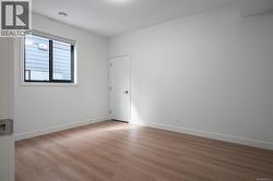 Spare room featuring light wood finished floors and baseboards -