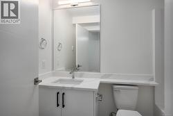 Half bathroom featuring vanity and toilet -