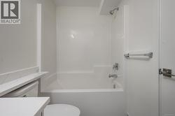 Bathroom featuring bathtub / shower combination and vanity -