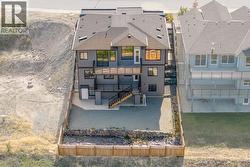 Rear view of property featuring stairs and a balcony -