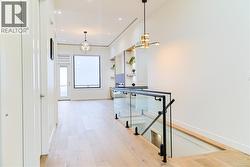 Hall with light wood-style flooring, recessed lighting, and a chandelier -