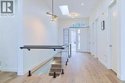 Foyer with a skylight and light wood-style flooring -