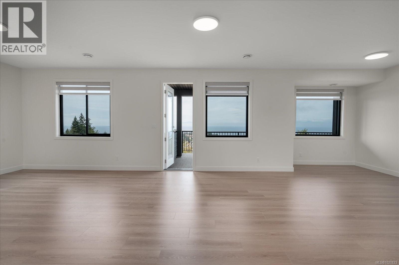 Empty room featuring light wood-type flooring and recessed lighting - 4680 Ambience Dr, Nanaimo, BC - Indoor