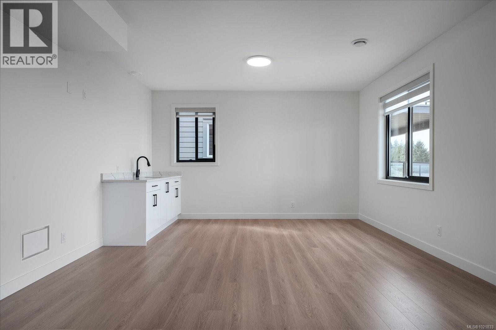 Spare room with light wood-style flooring and plenty of natural light - 4680 Ambience Dr, Nanaimo, BC - Indoor Photo Showing Other Room