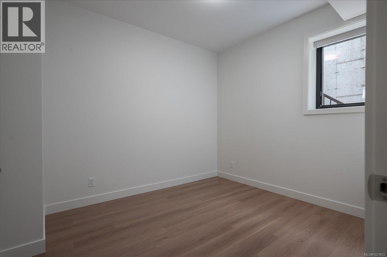 Empty room with wood finished floors and baseboards - 4680 Ambience Dr, Nanaimo, BC - Indoor Photo Showing Other Room