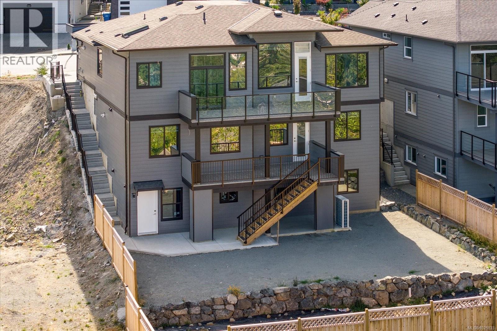 Rear view of house with a patio, stairway, roof with shingles, and a fenced backyard - 4680 Ambience Dr, Nanaimo, BC - Outdoor