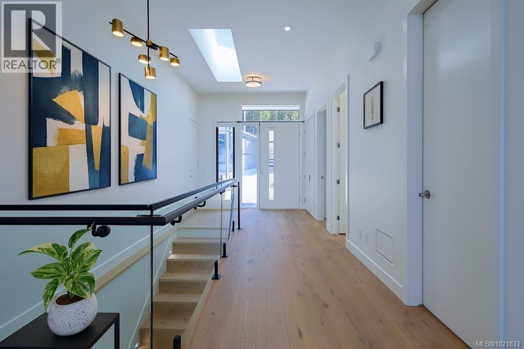 Hall featuring a skylight and light wood-style flooring - 4680 Ambience Dr, Nanaimo, BC - Indoor Photo Showing Other Room