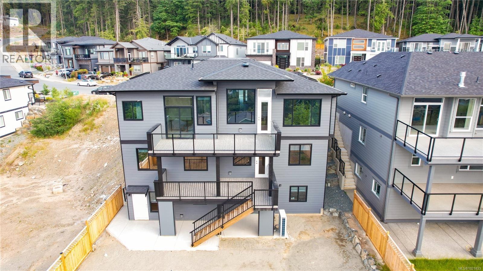 Rear view of house featuring a residential view, roof with shingles, stairway, and a patio - 4680 Ambience Dr, Nanaimo, BC - Outdoor