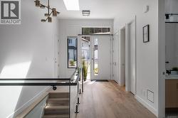 Entryway with a skylight and light wood finished floors -