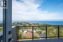 Balcony with a residential view and a water view -