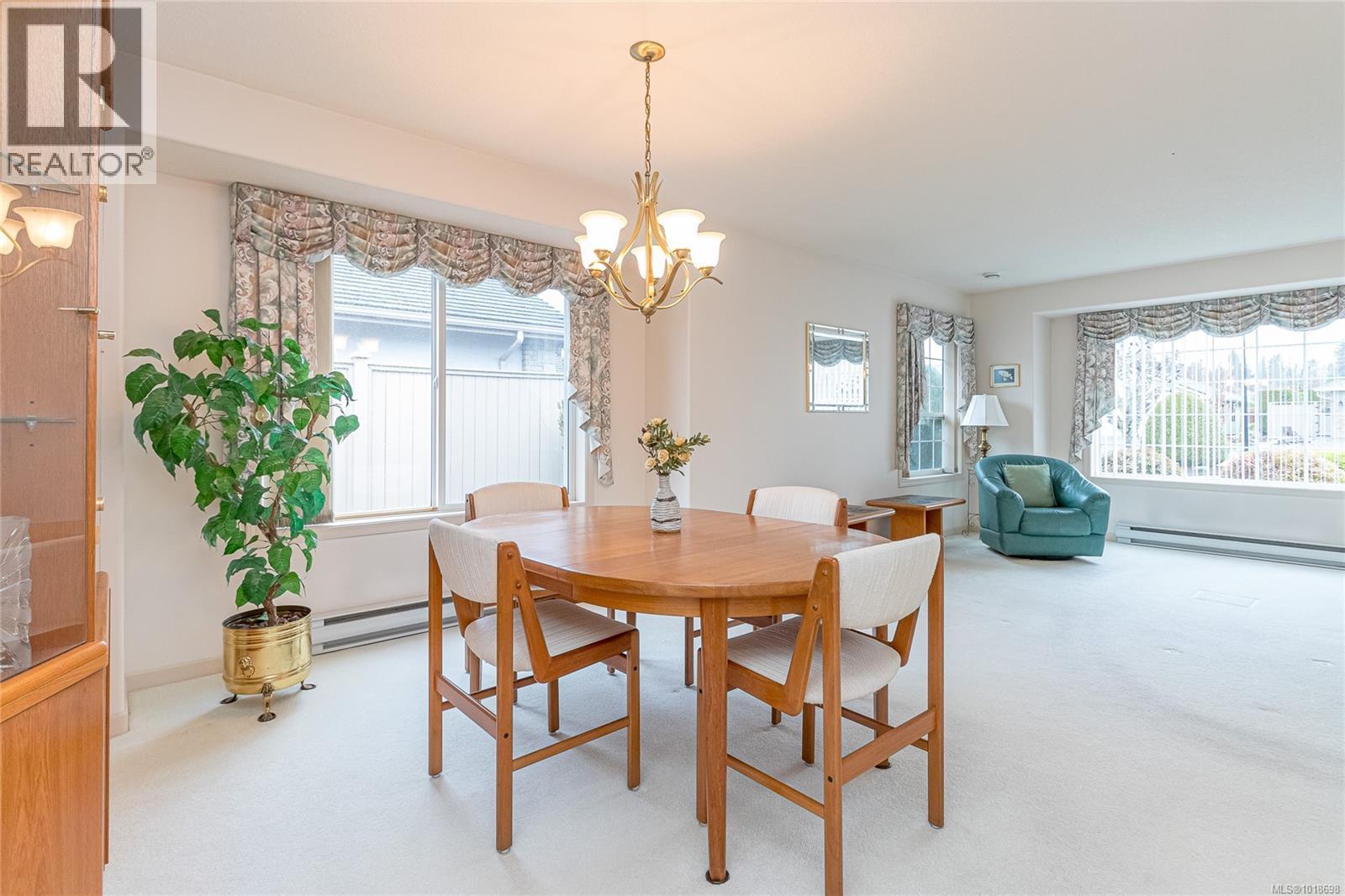 Dining Area w/ unfurnished living room in background - 751 Anson Pl, Qualicum Beach, BC - Indoor Photo Showing Dining Room