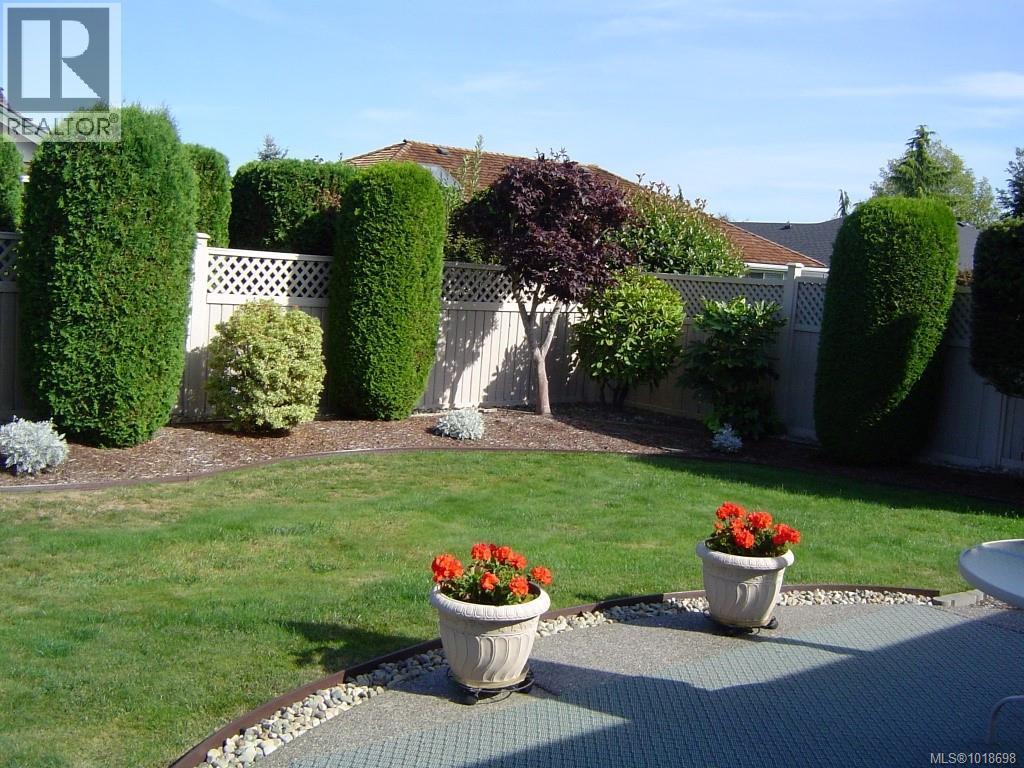 Backyard in the summer - 751 Anson Pl, Qualicum Beach, BC - Outdoor With Backyard